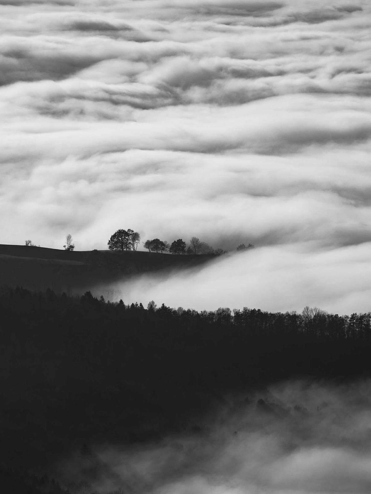 Fog rolling over dark hills